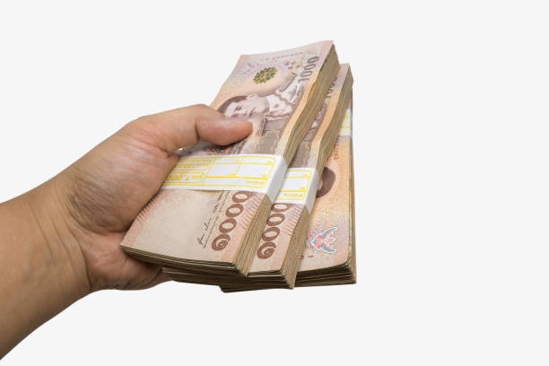 istock hand hold THB cash bundles, money stacks 1572043494