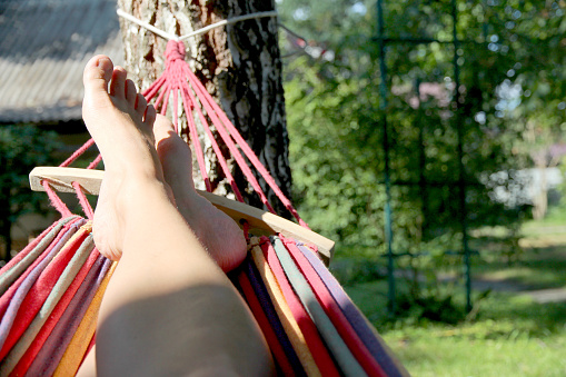Woman relaxing on Woman relaxing on a hammock by the outdoor village, mid shota hammock by the outdoor village, mid shot. High quality photo