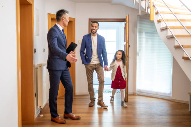 istock Estate agent showing house to customer 1572059009