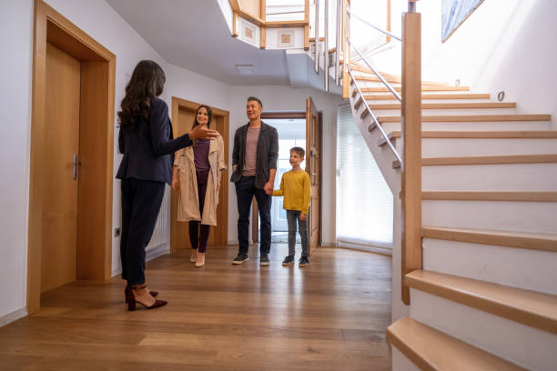 istock Estate agent talking with family 1572059036
