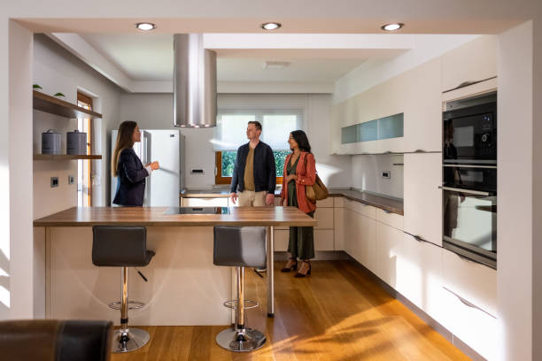 istock Estate agent talking with couple 1572059045