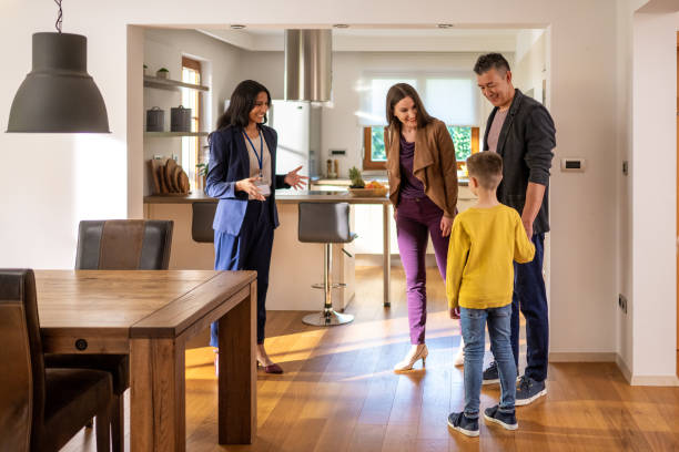 istock Estate agent talking with family 1572059057