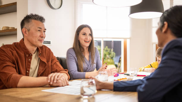 istock Couple talking with financial advisor 1572059058
