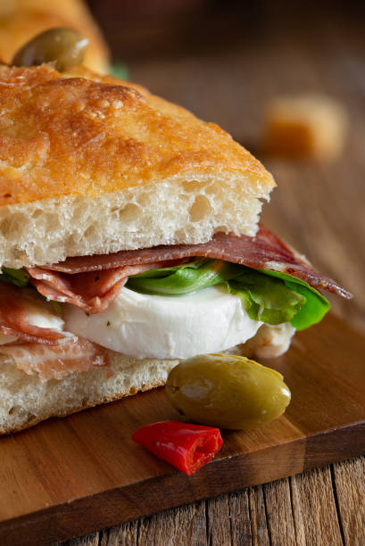 focaccia pizza  with ham, mozzarella, salads and olives