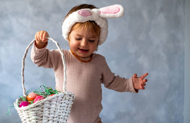 istock the baby is carrying a basket of Easter eggs 1572066114