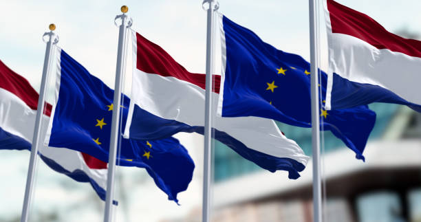 istock Netherlands and EU flags waving in the wind on a clear day 1572066120