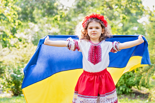 Ukraines Independence Flag Day. Constitution day. Ukrainian child girl in embroidered shirt vyshyvanka with yellow and blue flag of Ukraine in field. flag symbols of Ukraine. Kyiv, Kiev day