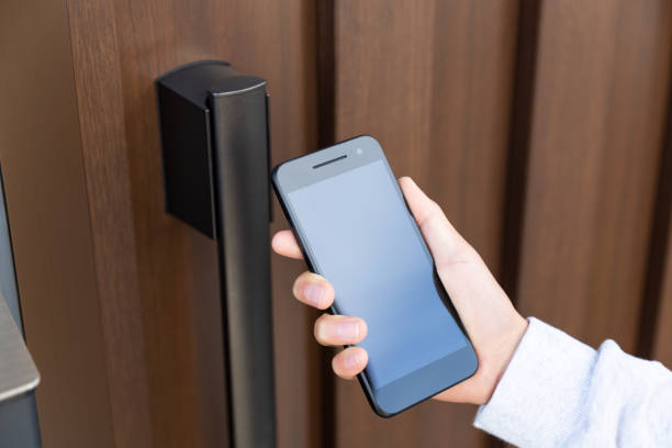 istock The hand that unlocks the front door with a smartphone. 1572091169