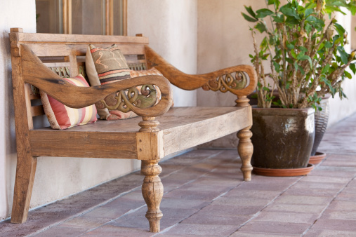 Old wooden Mexican Style bench on patio.