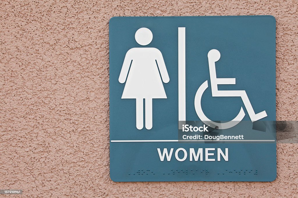 Public Restroom Public restroom sign with ADA symbol. Ada Township - Michigan Stock Photo