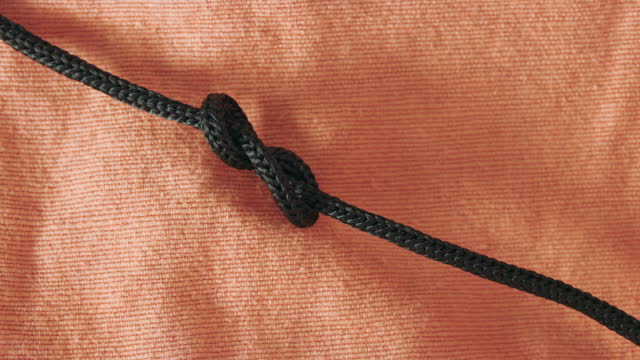 Make a knot with black rope