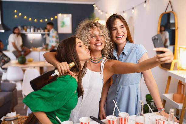istock Girlfriends taking selfies at a house party 1572129322