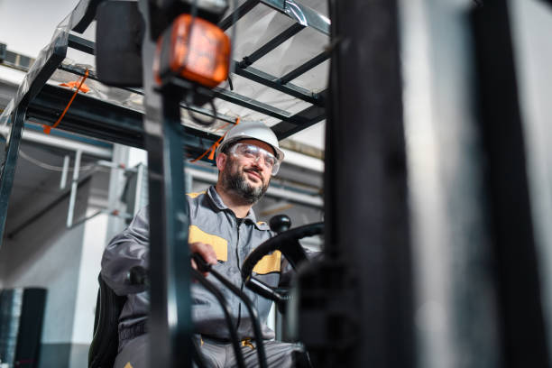 istock Smiling Male Warehouse Worker Satisfied With His Work 1572129492