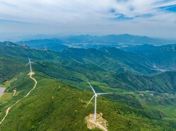 istock Wind farm on the mountain, blue sky and white clouds 1572129956