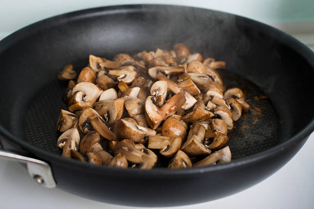 Frying Mushrooms Dinner Preparation. hott stock pictures, royalty-free photos & images