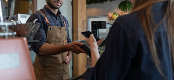 istock Woman use smartphone to scan QR code to pay in cafe restaurant with a digital payment without cash. Choose menu and order accumulate discount. E wallet, technology, pay online, credit card, bank app. 1572139772