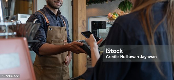 istock Woman use smartphone to scan QR code to pay in cafe restaurant with a digital payment without cash. Choose menu and order accumulate discount. E wallet, technology, pay online, credit card, bank app. 1572139772