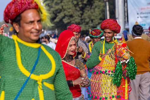 Bikaner, Rajasthan, India - January 13 2023: Camel Festival, Portrait of an rajasthani male artist performing the horse dance in traditional attire on the streets of bikaner during parade.