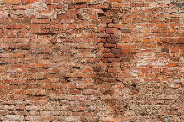 istock Old brick wall. The wall is red and there is mortar between the joints. 1572219151