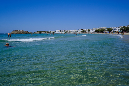 Crowded beach on the seafront of Naxos, Greece on July 9, 2023.