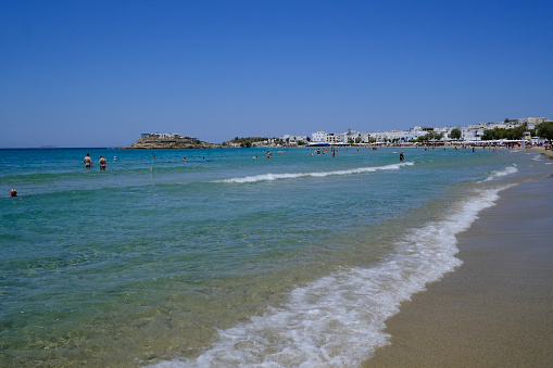 Crowded beach on the seafront of Naxos, Greece on July 9, 2023.