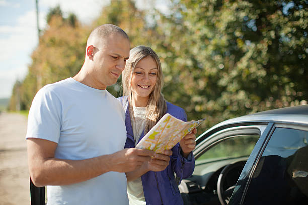 istock tourist couple looking at the map on road 157226786