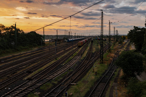 istock Sunrise at the train station with some freight trains 1572274202