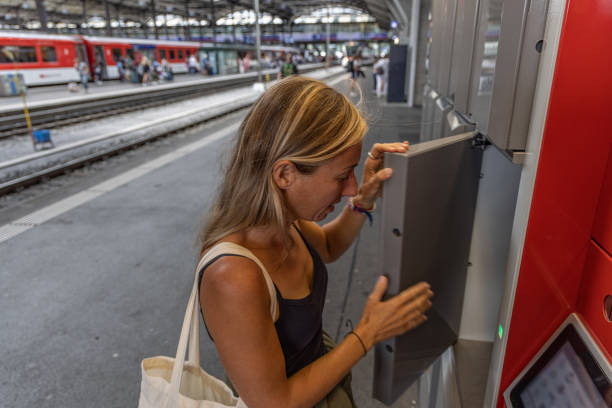 istock Woman opening locker door at train station 1572287327