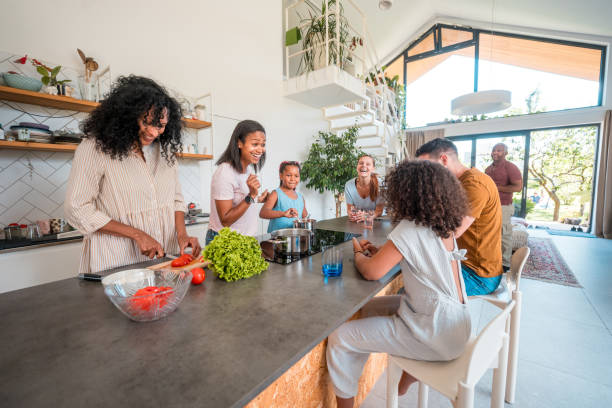 istock Diverse Family Cooking Feast in Modern Home 1572293714