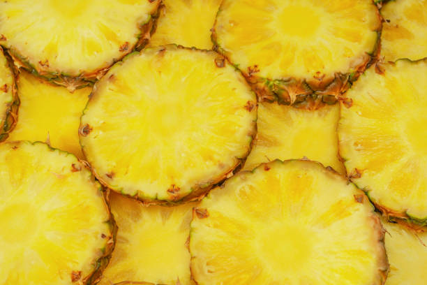 istock Pineapple juicy yellow slices as a background. 1572308947