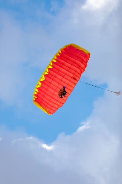 istock Jump in tandem skydivers-athletes with a parachute. 1572338301