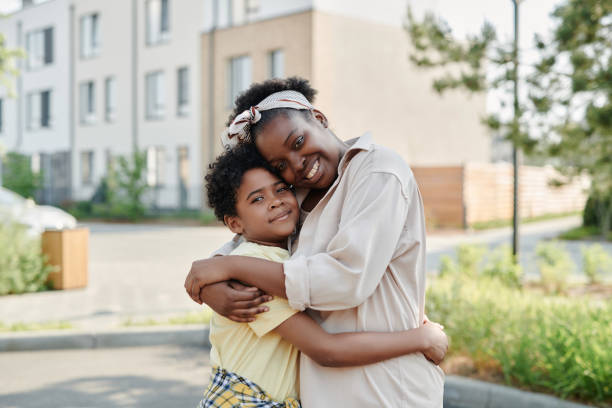 istock Mother embracing her son outdoors 1572361785