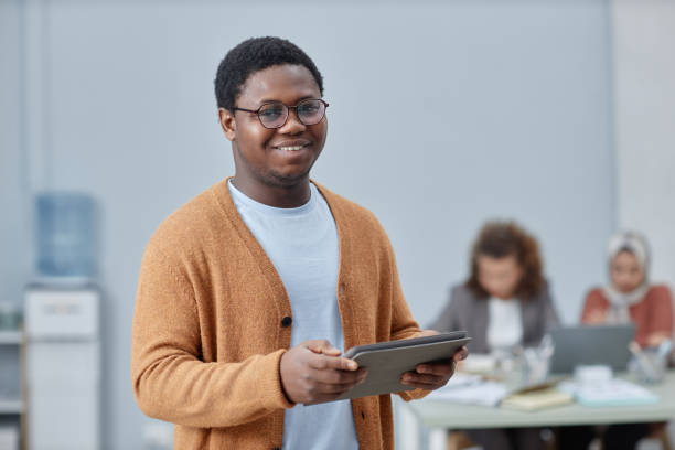 istock Happy young African American male analyst with tablet looking at camera 1572377423