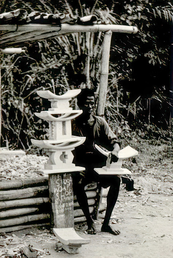 Dodowa, Greater Accra, Ghana - March 1959: Craftsmen carving traditional wooden stools in Dodowa, Greater Accra, Ghana