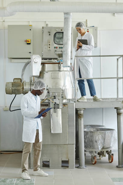 istock People wearing lab coats in factory workshop on different levels 1572385017