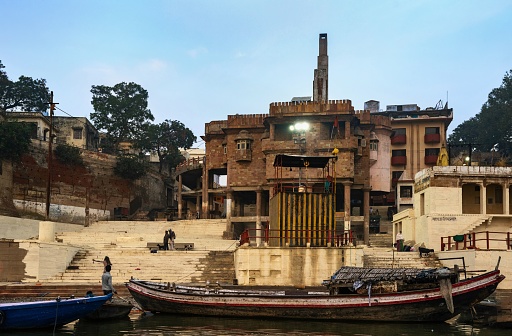 Varanasi, India, November 23, 2015: View of a ghat on the Ganges River in the holy city of Varanasi at dawn.