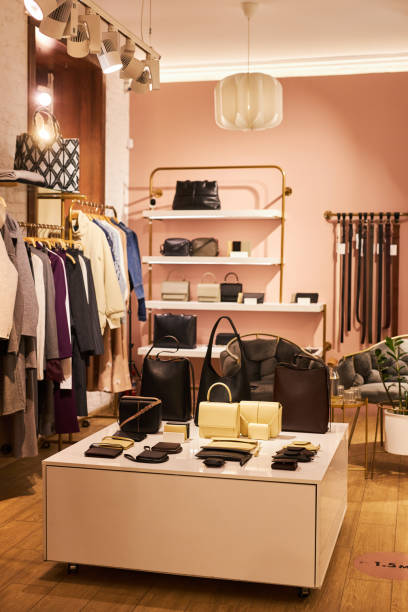 istock Empty clothing boutique with focus on bags display 1572391423