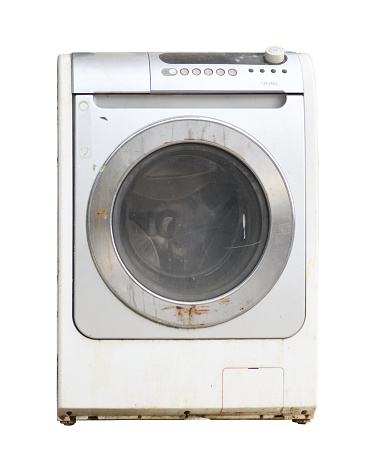 Old rusty broken washing machine isolated on white background.