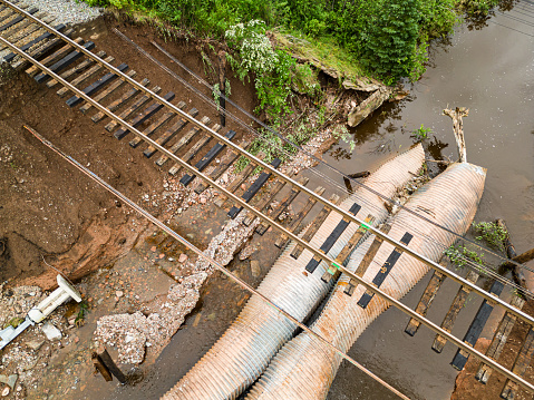 Flash flooding after record breaking rainfall erodes culverts beneath an important rail line.