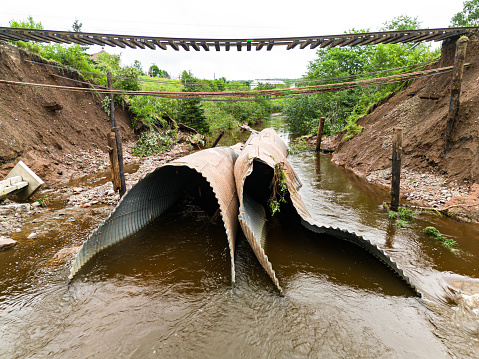 Flash flooding after record breaking rainfall erodes culverts beneath an important rail line.