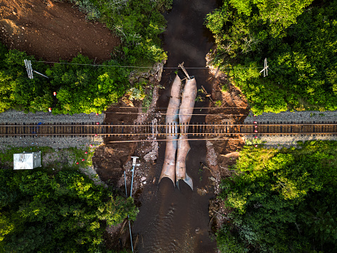Flash flooding after record breaking rainfall erodes culverts beneath an important rail line.