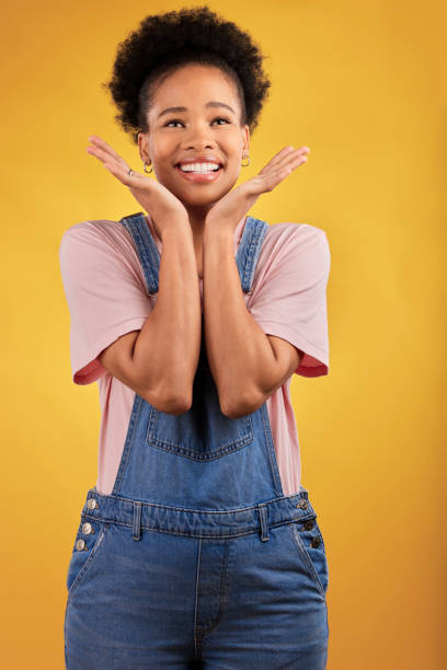 Thinking, choice and woman with a smile, decision and problem solving on a yellow studio background. Female person, opportunity or happy model with happiness, solution and ideas with wonder and emoji