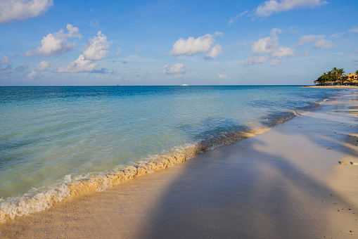 Beautiful view of sandy beach of Eagle Beach with blue water of Atlantic Ocean on island of Aruba.
