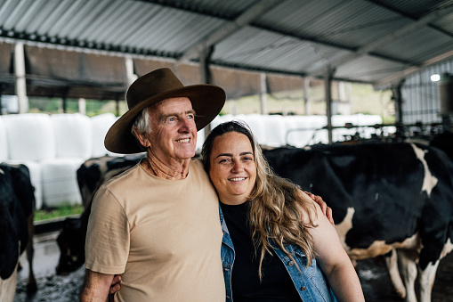 Portrait of father and daughter cattle ranchers