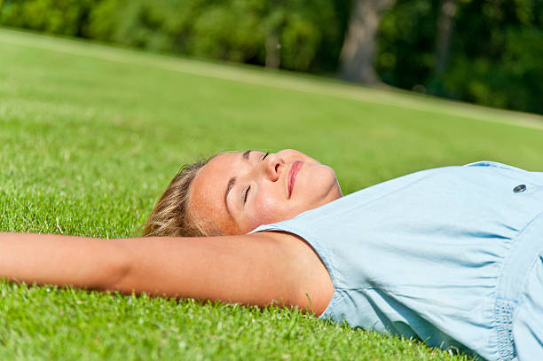 istock Beautiful young woman in hat over the grass 157249358
