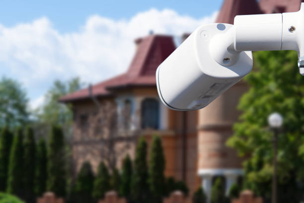 istock Security camera and private house on the background. 1572496635