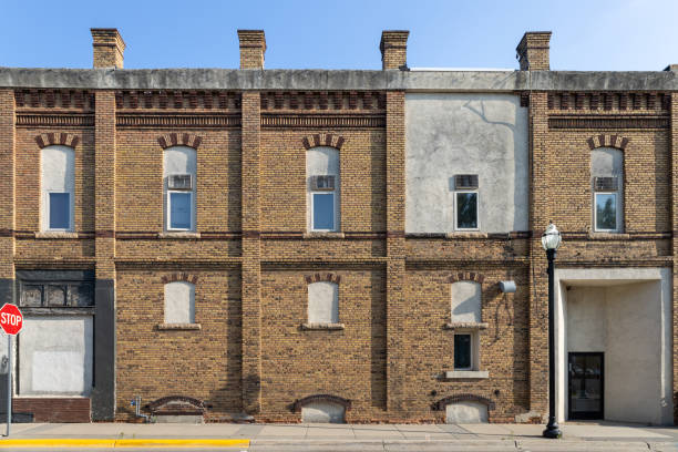 istock Yellow and brown brick wall facade enclosed arched windows 1572499840