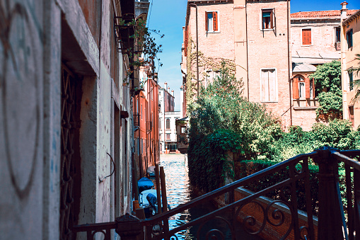 Small water canal between ancient houses in Venice, Italy