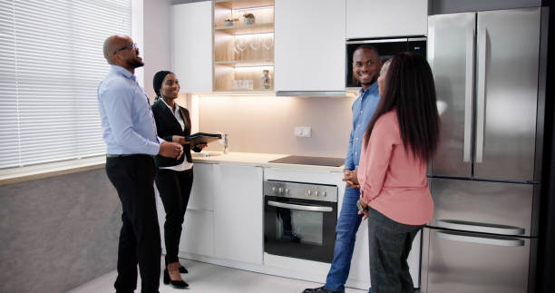 istock Young Woman Checking Kitchen Cabinet During Meeting 1572514007