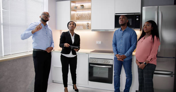 istock Real Estate Agent Showing House Kitchen 1572514022